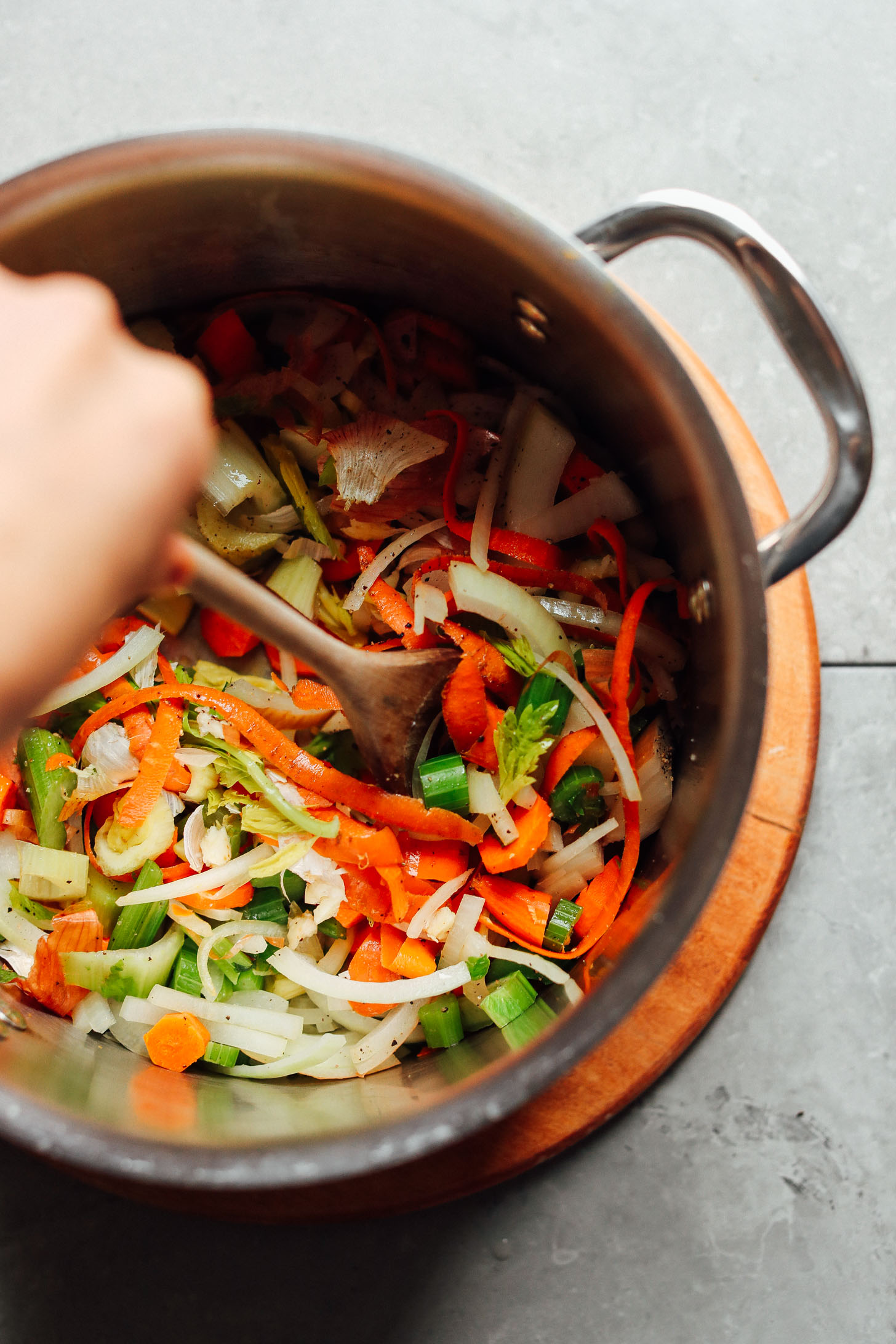 Stirring a big pot with vegetables for making the BEST homemade vegetable broth
