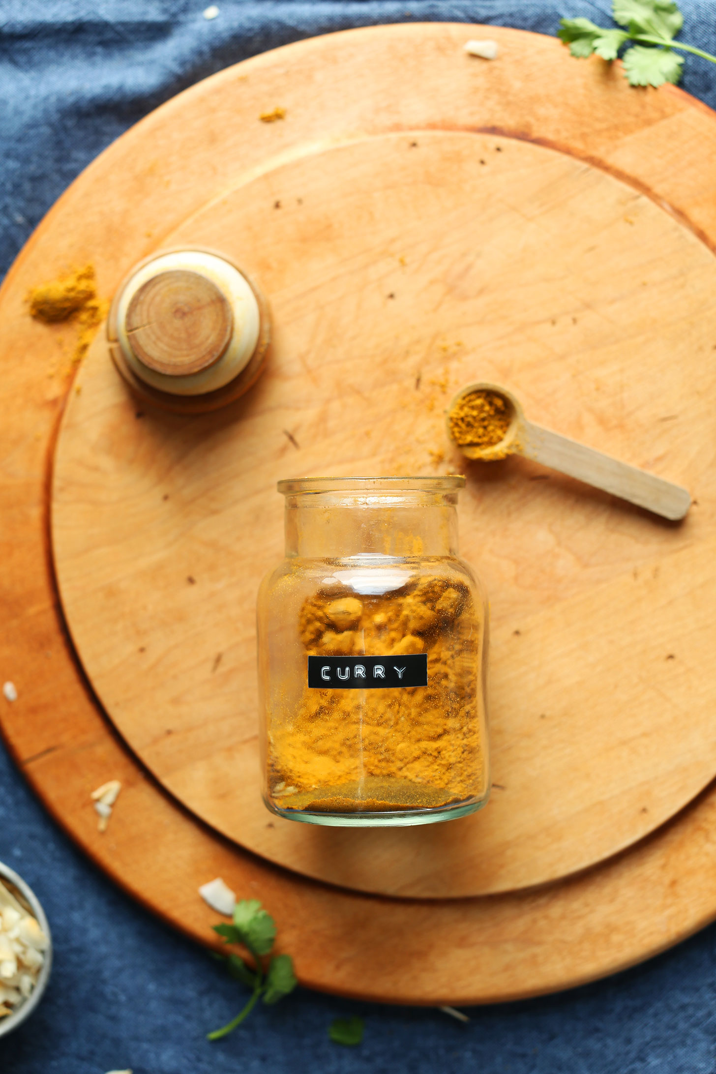 Jar and spoonful of our homemade curry powder